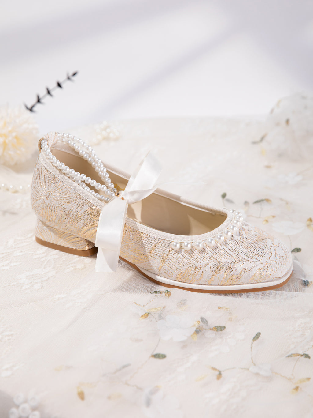Mary Jane flats with pearl ankle strap detail in natural light