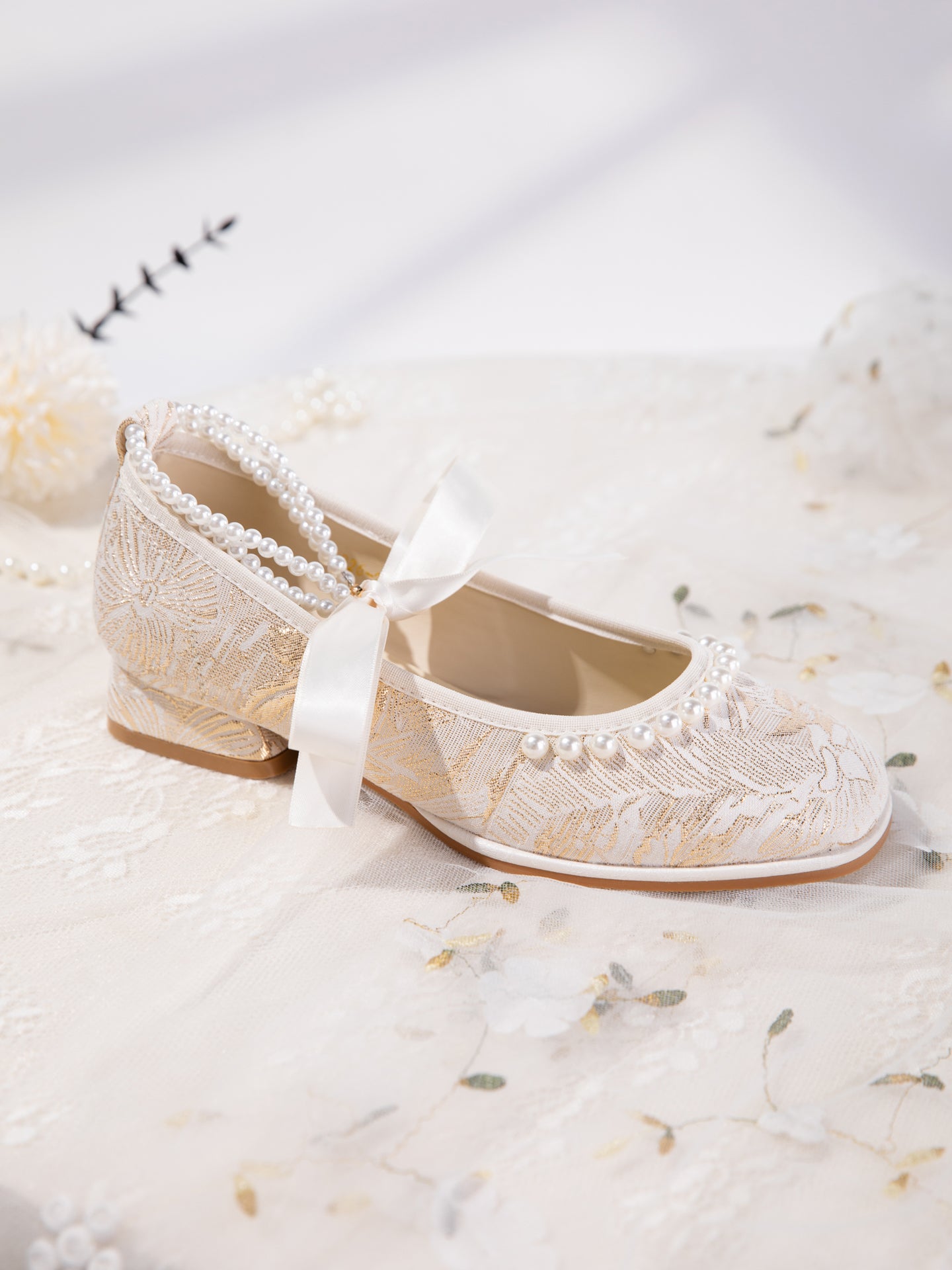 Mary Jane flats with pearl ankle strap detail in natural light